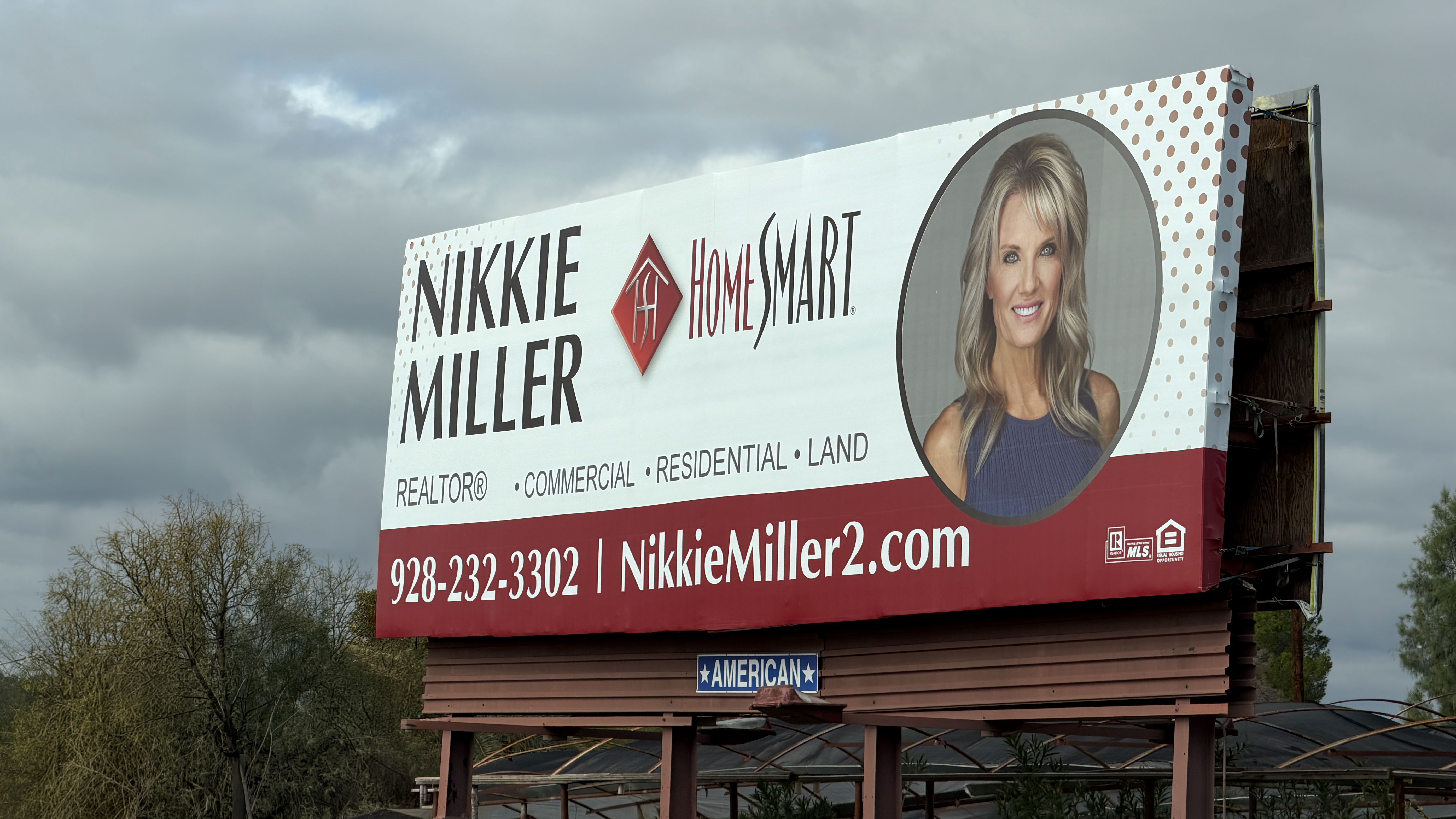 CMQ Headshots client Nikki on a billboard - real estate agent headshot used in outdoor advertising
